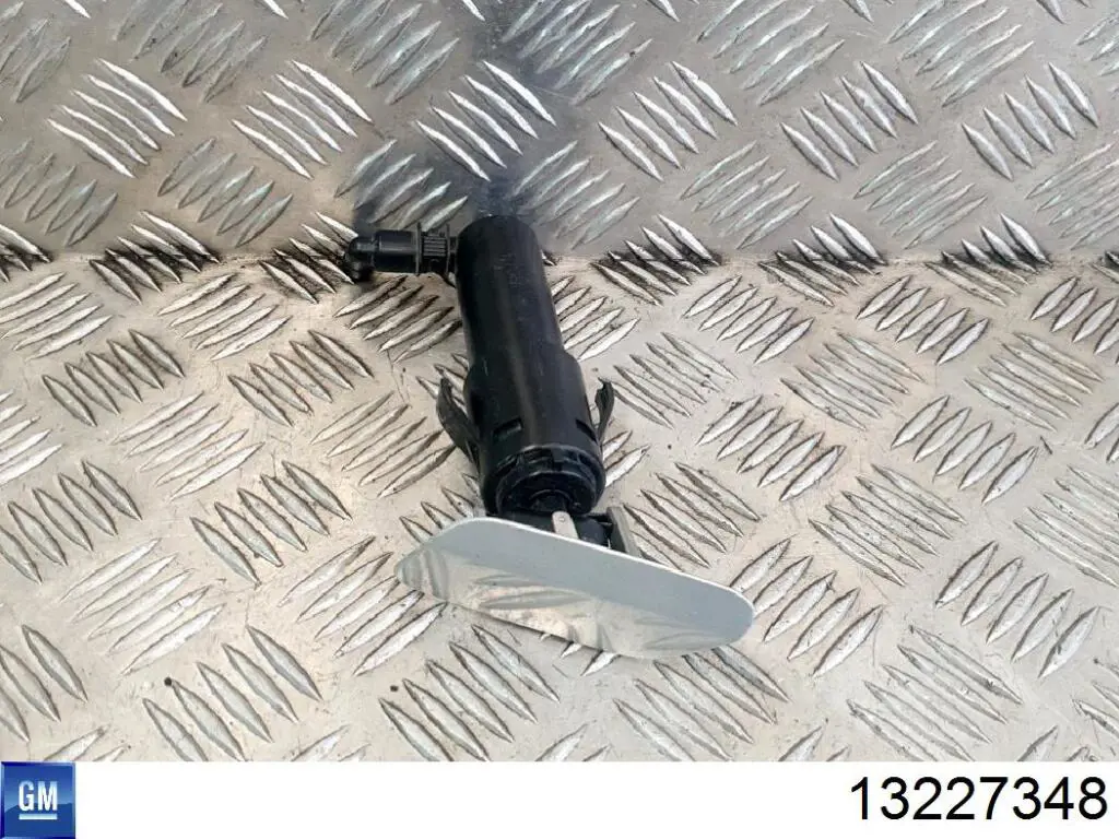 13227348 General Motors soporte boquilla lavafaros cilindro (cilindro levantamiento)